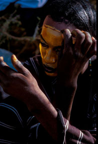 Woodabe beauty contest Woodabe tribesman applies paint to his face