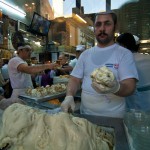 ice cream parlor in Damascus Souk a man stands by a table heaped with ice cream