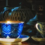 blue and white teacup with sunburst on lip of cup