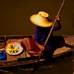 Thai floating market woman paddling boat