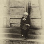 an elderly Chinese woman sits in solitude