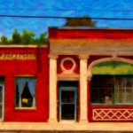 bright red store fronts against a deep blue sky