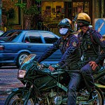 Bangkok police save fuel by riding double