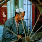 Uigar man spinning silk from cocoons in Kashgar,