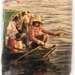 Woman rows her floating shop on Tonle Lake