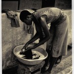 Beautiful young woman washing clothes in Togo West Africa