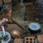 woman prepares food in a burma village