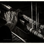 hands of elderly woman at her loom Romania
