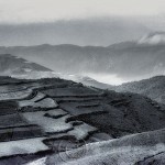 Landscape of China's red earth region with fog rising.