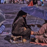 Moroccan woman consults a fortune teller in Jemaa El Fnaa