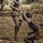 Photograph of Somba men in northern Benin demonsrate their fighting skills.