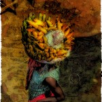 Woman in Lome market carries a heavy load of bananas on her head