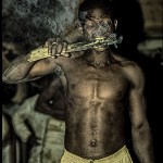 A man bites into a burning ember during a voodoo ceremony in northern Togo.