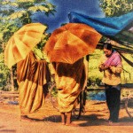 Two Buddhist Monks accept food from a woman in a prayerful pose