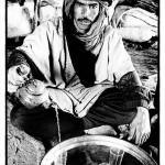 A Berber nomad man sitting in his tent pours tea for guests