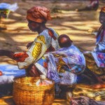 An African woman with her children sells her produce in the market