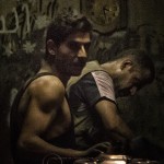 A low key portrait of two coppersmiths at work in Damascus.